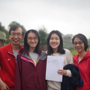 a happy student with her exam results and her family