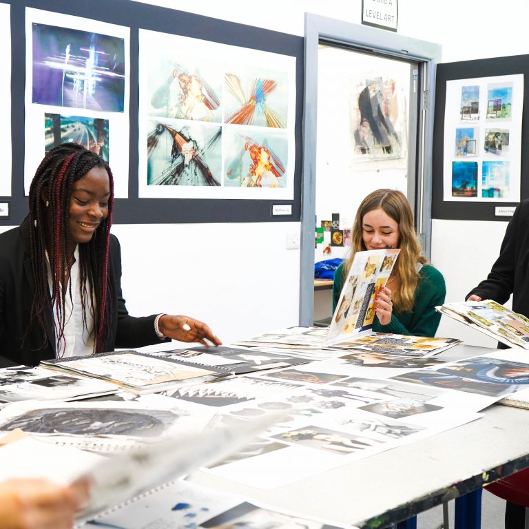 art students on a large table together