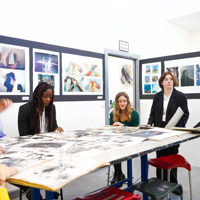 art students on a large table together