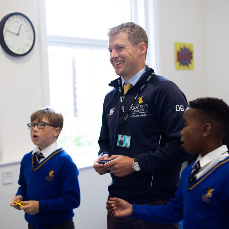 a member of staff and 2 students playing on the Switch