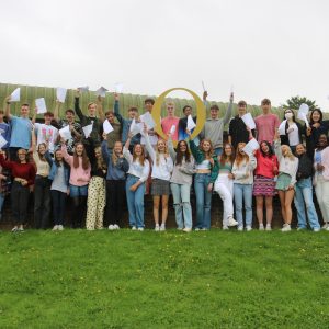 students in a big group together with their results