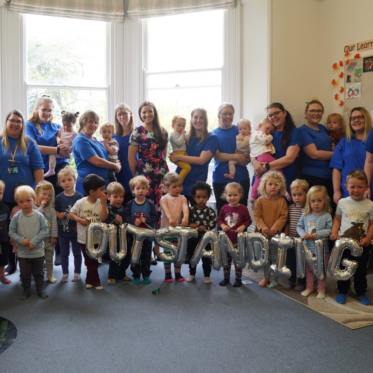 Students and teachers celebrating the Outstanding award