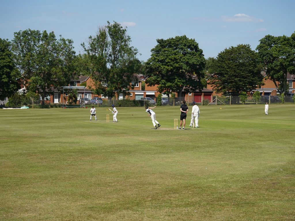 Students playing cricket