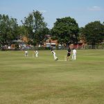 Students playing cricket