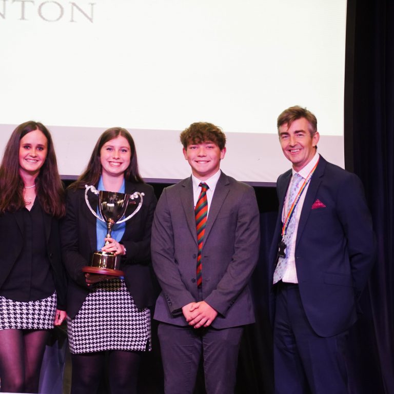 pupils holding a trophy