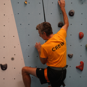 Headmaster Julian Noad climbing the climbing wall
