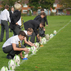 Boys lining up rugby balls