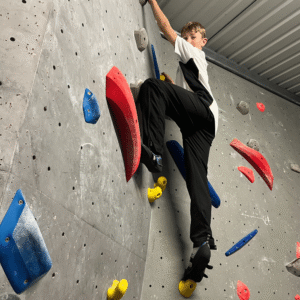 Boy on a climbing wall.