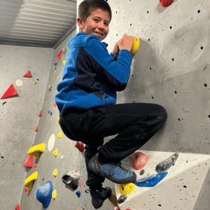 Boy on a climbing wall.