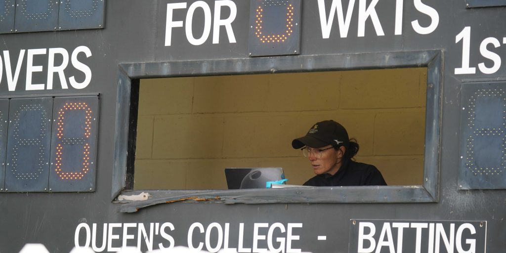Mrs Foster sitting next to the score board.