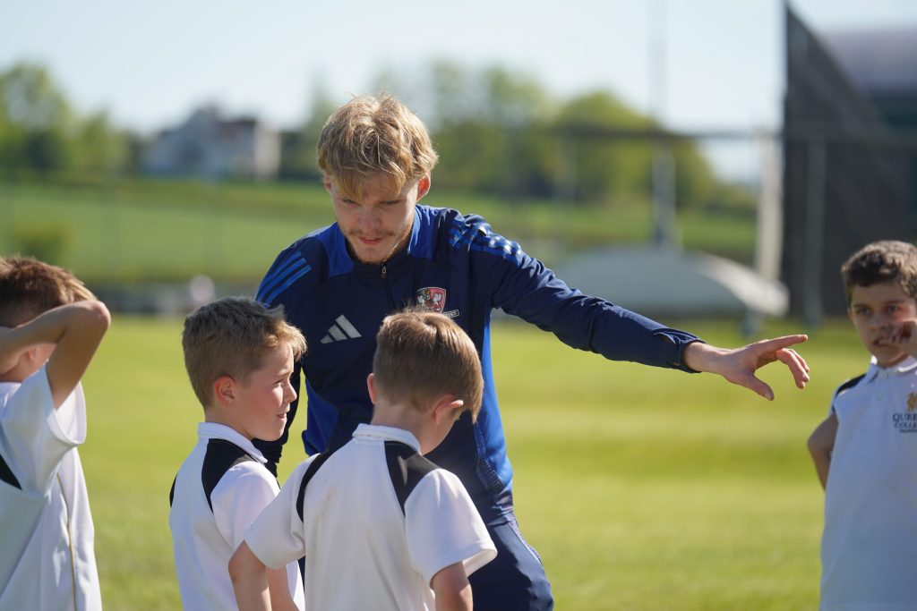 Exeter City FC Community Trust Coach instructing Queen's College Pupils