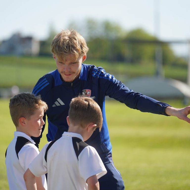 Exeter City FC Community Trust Coach instructing Queen's College Pupils